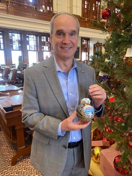 State Rep. Mike Schofield holds the Katy-themed ornament before placing it on the Christmas tree in the Texas House of Representatives chamber.